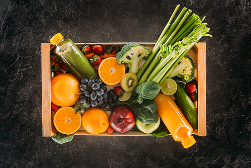 top view of detox drinks and various healthy food in wooden box