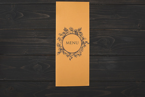 top view of decorative restaurant menu on wooden table