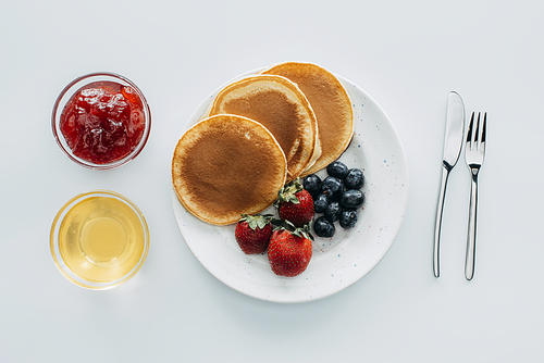 top view of sweet pancakes with berries on white table