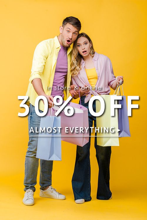 beautiful surprised couple holding shopping bags on yellow, 30 percent off sale illustration