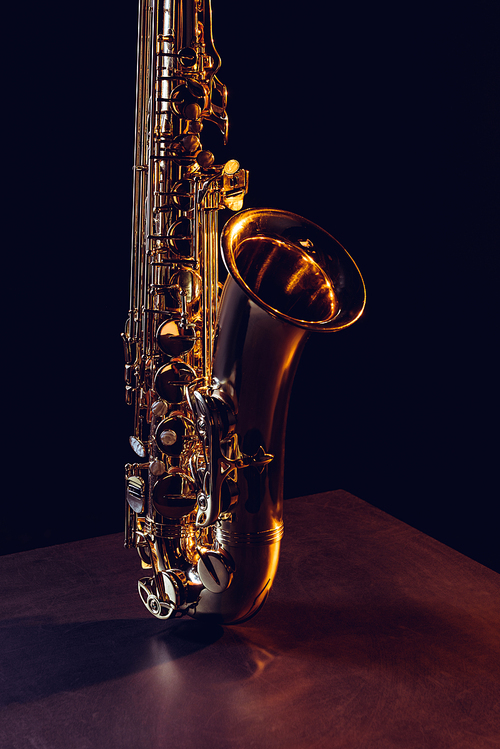 close-up view of shiny professional saxophone on black