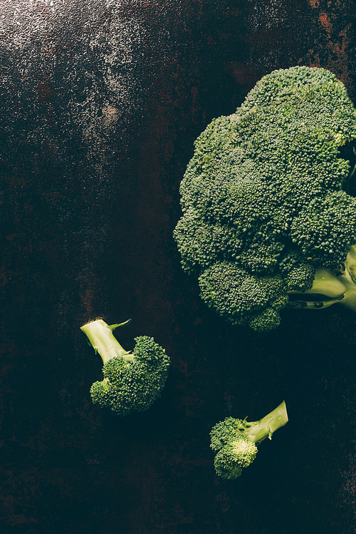 top view of ripe broccoli on grey dark table