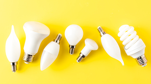 top view of various types of light bulbs on yellow