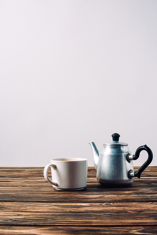 cup of coffee with vintage grinder on rustic wooden table