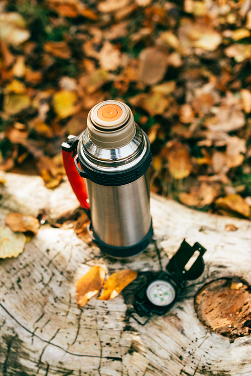 top view of metallic camping thermos on beautiful autumnal background