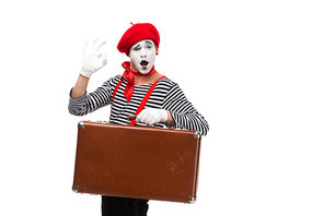 mime holding brown suitcase and showing ok sign isolated on white