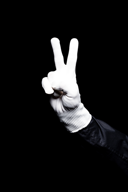 cropped image of mime showing peace sign isolated on black