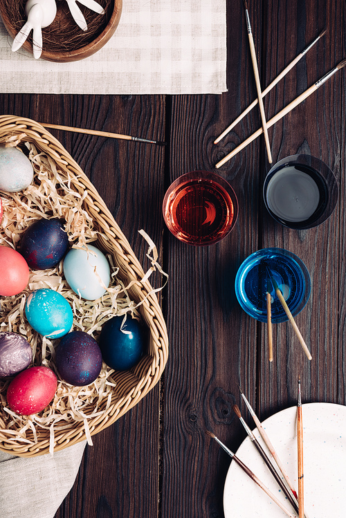 Coloring and Easter eggs on wooden table