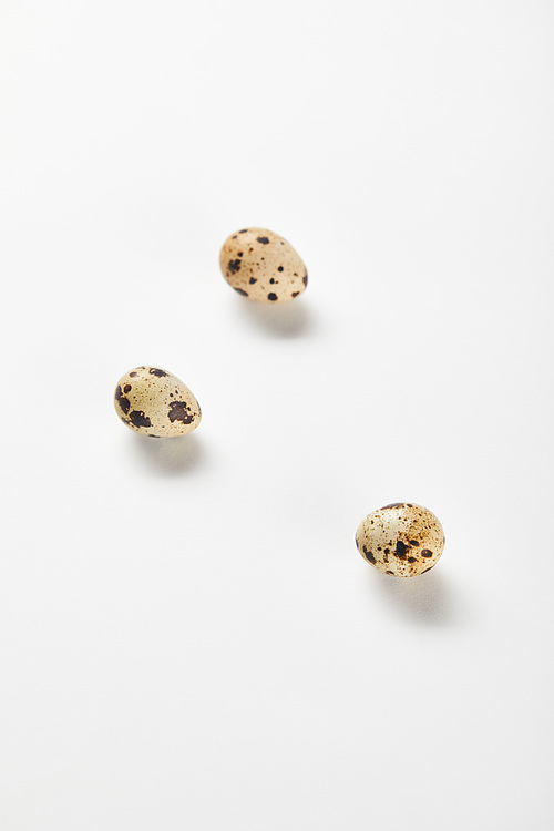top view of quail eggs on white surface