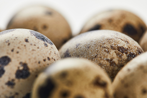 selective focus of quail eggs on white surface