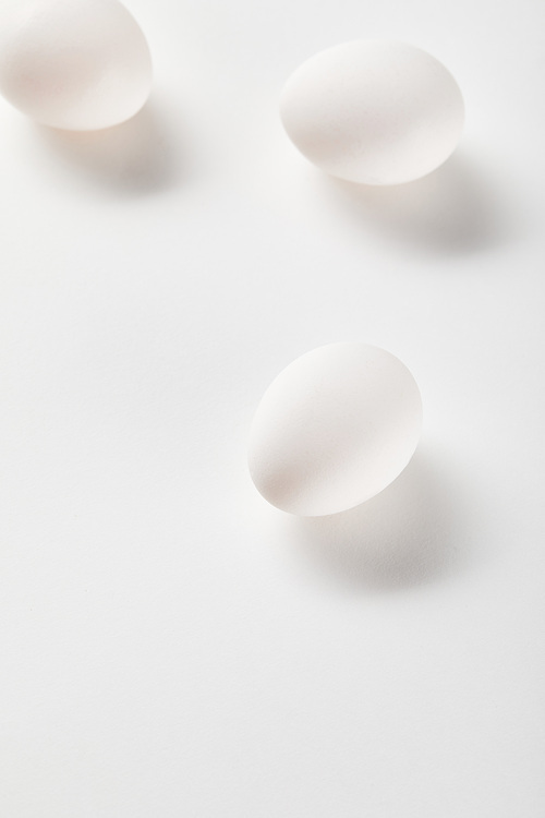 top view of chicken eggs on white surface