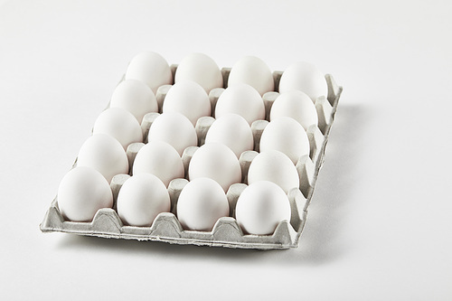 chicken eggs in carton box on white surface