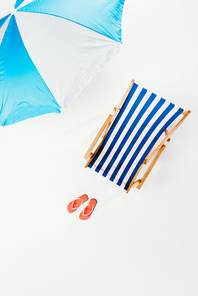 top view of beach umbrella| striped beach chair and flip flops isolated on white