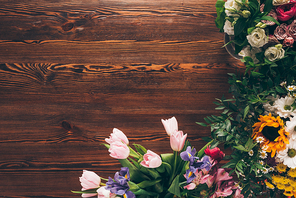 top view of tulips and roses on table in flower shop