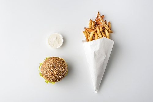 top view of french fries in paper cone| hamburger and mayonnaise| isolated on white