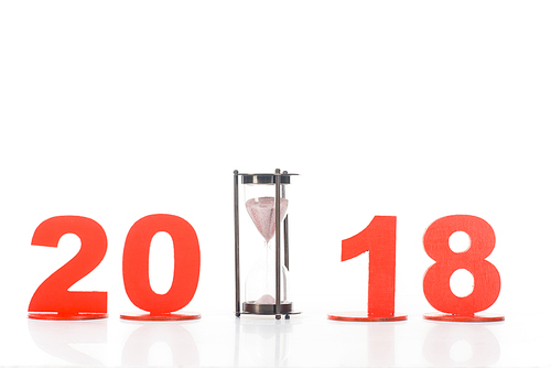 close up view of sand clock and 2018 year sign isolated on white