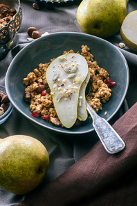 overhead view of granola with pear pieces in bowl