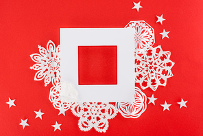 white christmas frame with stars and paper snowflakes around| isolated on red