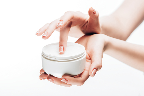 cropped shot of woman taking moisturizing cream from jar isolated on white