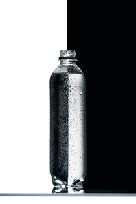 plastic bottle of water on half black and white background