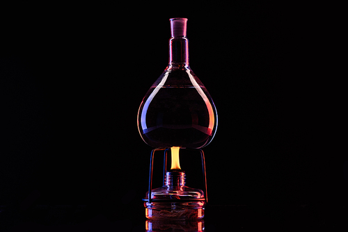 heating glass jar with liquid in laboratory on black