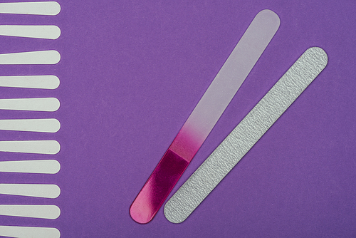 top view of different nail files isolated on purple