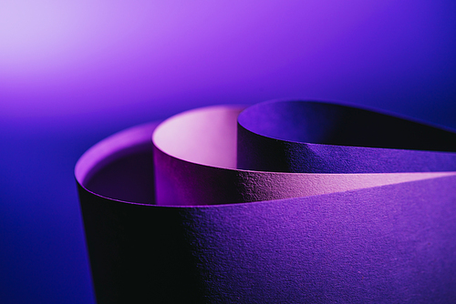 close up view of arcs of purple and pink paper on purple