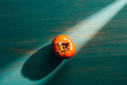 top view of persimmon on table with light and shadow