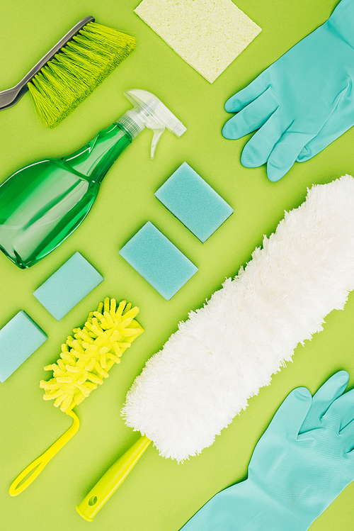 top view of cleaning supplies isolated on light green