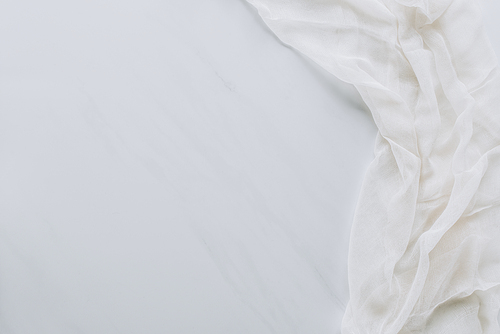 top view of white fabric and blank grey background