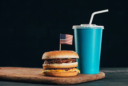 close up view of burger with american flag and soda drink| presidents day celebration concept