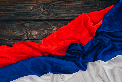 close up view of russian flag on dark wooden surface