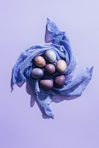 top view of traditional easter eggs on gauze| on purple
