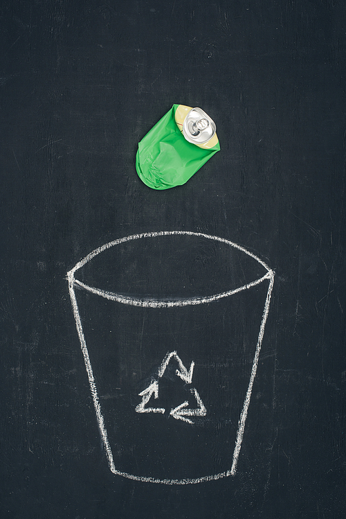 metal can falling into drawn trash bin with recycle sign on chalkboard