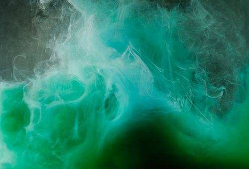 abstract flowing white| green and blue ink on black background
