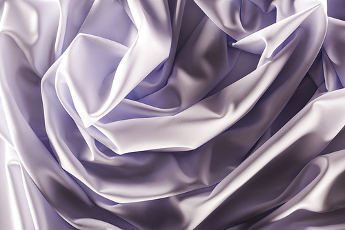 full frame of folded elegant purple silk fabric as background
