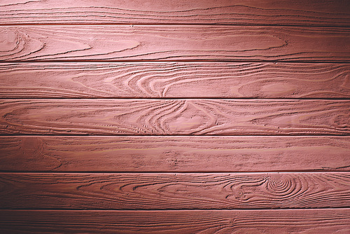 Wooden fence planks background painted in pink
