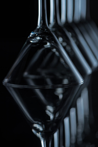 close up of martini glasses on black with reflections
