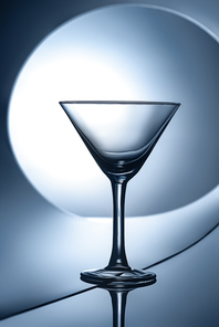 silhouette of empty martini glass on geometric background