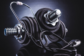 close-up view of dumbbells and stethoscope, healthy lifestyle concept