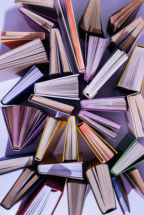 elevated view of scattered stack of books on table