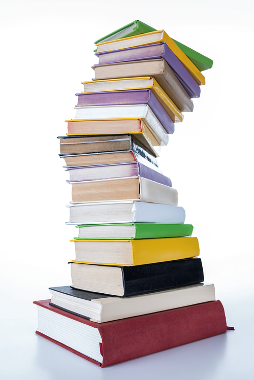 stack of different colored books on white tabletop