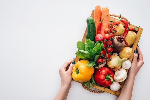 cropped shot of person holding box with fresh ripe organic vegetables isolated on white