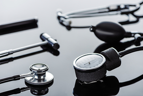 selective focus of tonometer, reflex hammer and stethoscope on glass surface