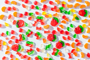 top view of tasty scattered jelly candies on white