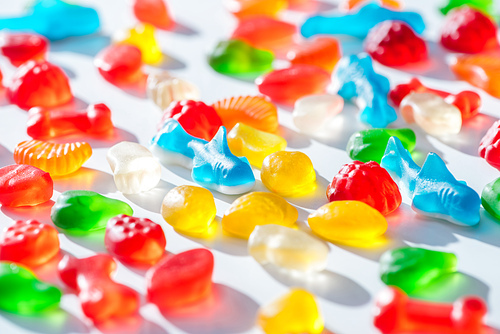 different colored jelly candies on white surface