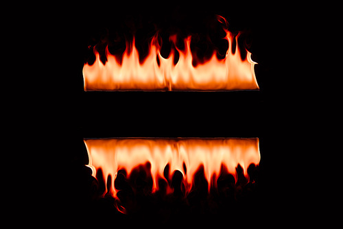 close up view of burning flame lines on black backdrop