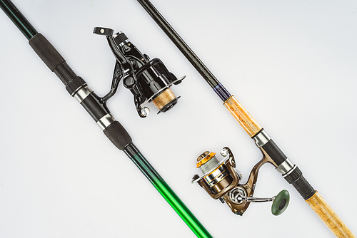 flat lay with arranged fishing rods isolated on white, minimalistic concept