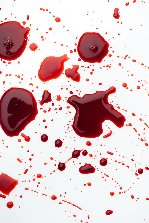 top view of messy blood droplets on white surface