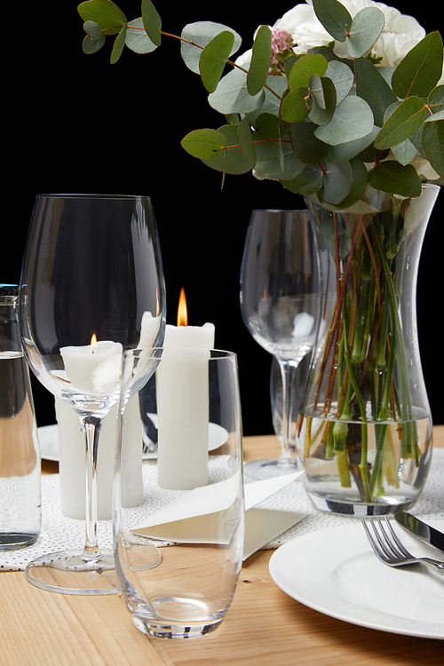 Table setting with glasses on table with candles